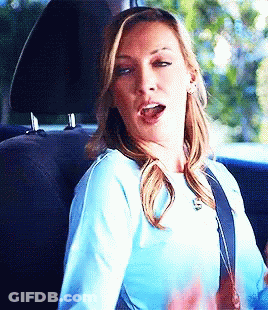 Woman In Blue Shirt Sitting In Back Seat Mouth Open GIF