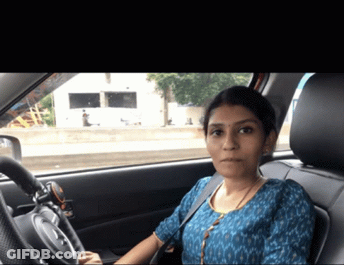 Woman In Blue Shirt Sitting In Car GIF