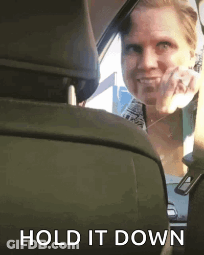Woman In Blue Shirt Sitting In Car With Mouth Open GIF