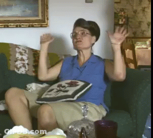 Woman In Blue Shirt Sitting On Couch GIF