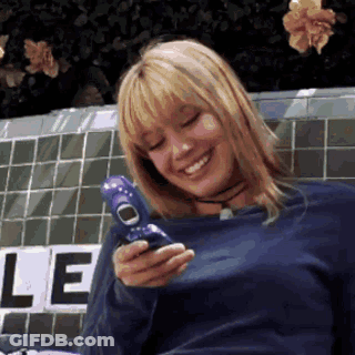 Woman In Blue Shirt Smiling Holding Blue Phone GIF