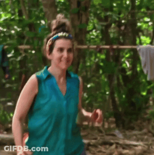 Woman In Blue Shirt Smiling In Woods GIF