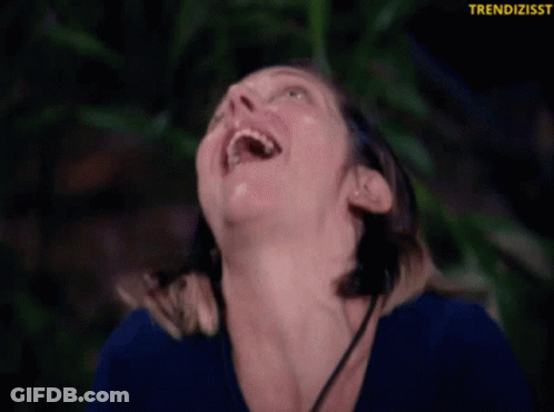 Woman In Blue Shirt Smiling Upward GIF