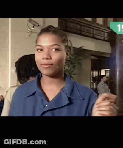 Woman In Blue Shirt Standing In Front Of Camera GIF