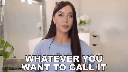 Woman In Blue Shirt Standing In Front Of Mirror GIF