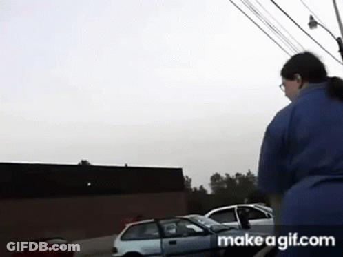 Woman In Blue Shirt Standing In Front Of White Car GIF
