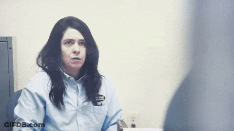 Woman In Blue Shirt With AJ Badge GIF