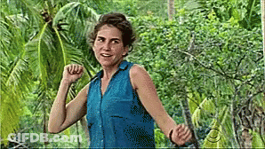 Woman In Blue Shirt With Arms Outstretched In Jungle GIF