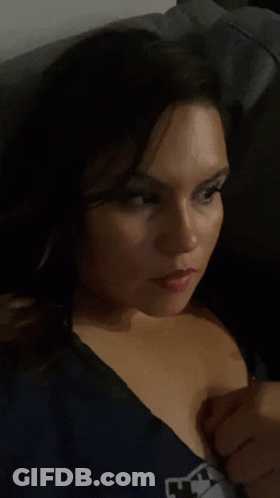 Woman In Blue Shirt With M Taking Selfie GIF