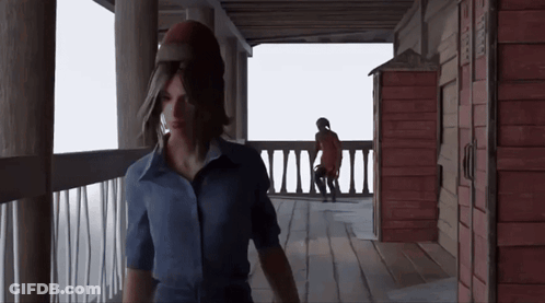 Woman In Blue Shirt With Man In Red Coat On Porch GIF
