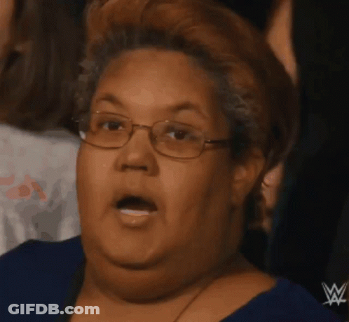 Woman In Blue Shirt With Wrestling Logo GIF