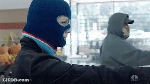 Woman In Blue Ski Mask Next To Man In Hooded Jacket GIF