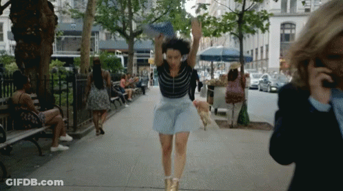 Woman In Blue Skirt Running Down Street GIF