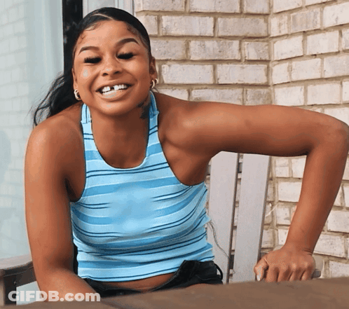 Woman In Blue Striped Tank Top Smiling In Chair GIF