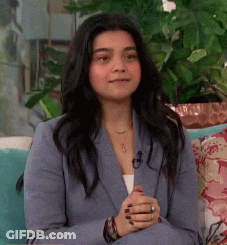 Woman In Blue Suit Sitting On Couch Smiling GIF