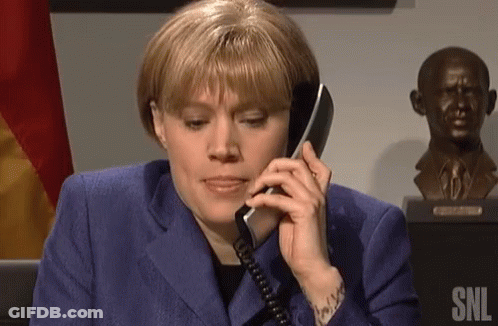 Woman In Blue Suit Talking On Phone GIF