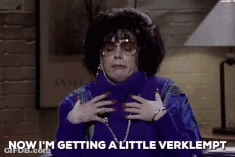 Woman In Blue Sweater And Sunglasses Holding Chest GIF