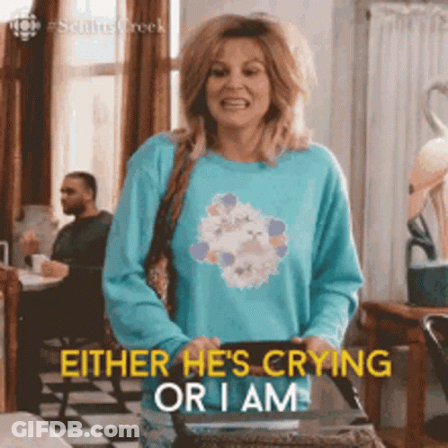 Woman In Blue Sweater Holding Bag Says Either He's Crying Or I Am GIF