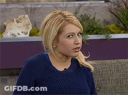 Woman In Blue Sweater Looking At Camera GIF