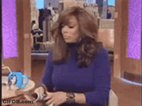 Woman In Blue Sweater With Coffee And Magazine GIF