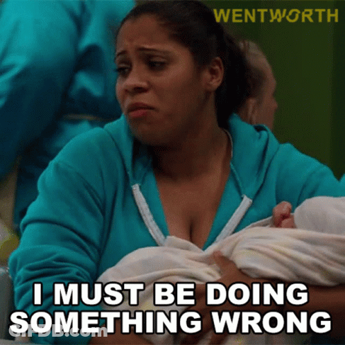 Woman In Blue Sweatshirt Holding Baby Saying I Must Be Doing Something Wrong GIF