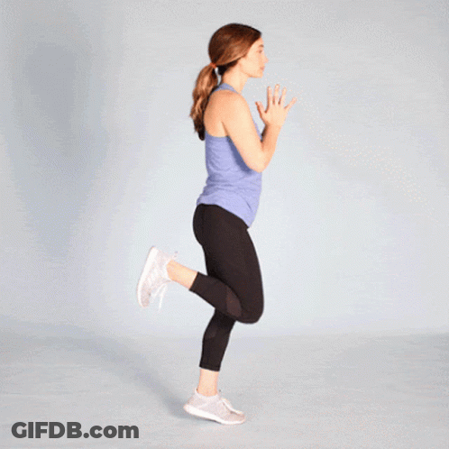 Woman In Blue Tank Top And Black Leggings Jumping GIF