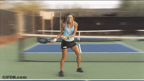 Woman In Blue Tank Top And Black Skirt Holding Tennis Racquet GIF