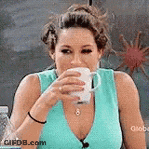 Woman In Blue Tank Top Drinking From Cup GIF