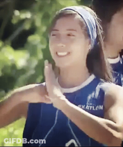 Woman In Blue Tank Top High-Fiving Another Woman GIF