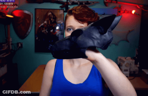 Woman In Blue Tank Top Holding Black Object GIF