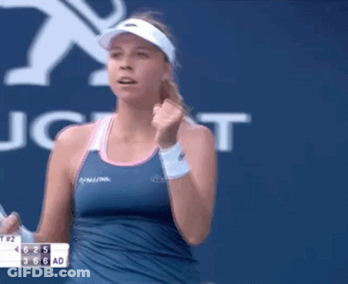 Woman In Blue Tank Top Holding Tennis Racket GIF