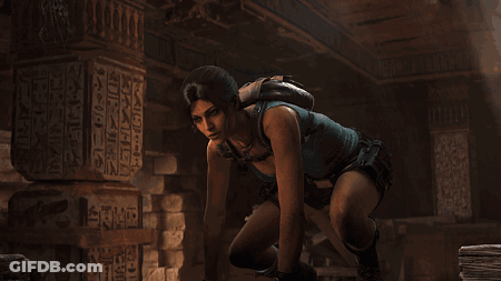 Woman In Blue Tank Top Kneeling In Front Of Egypt Pillar GIF