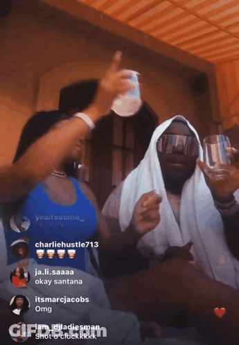 Woman In Blue Tank Top Next To Man In White Robe GIF