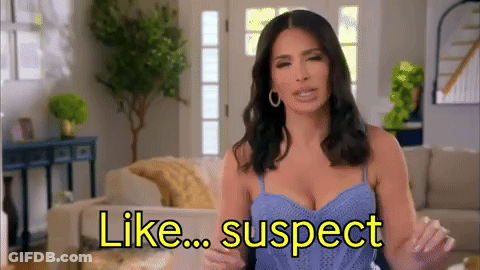 Woman In Blue Tank Top Sitting On Couch Saying Like Suspect GIF