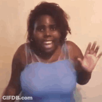 Woman In Blue Tank Top Smiling And Waving GIF