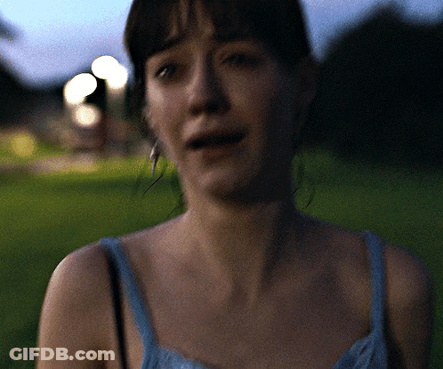 Woman In Blue Tank Top Standing In Grass GIF