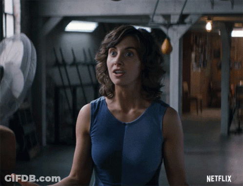 Woman In Blue Tank Top With Netflix Logo GIF