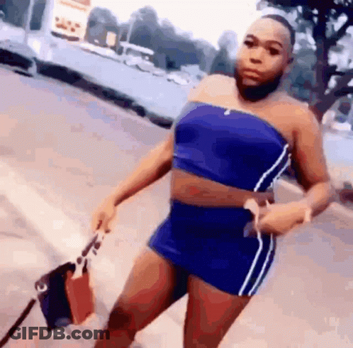 Woman In Blue Top And Shorts On Sidewalk GIF