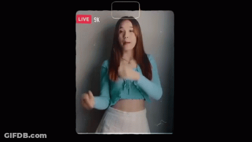 Woman In Blue Top And White Skirt Singing Live GIF