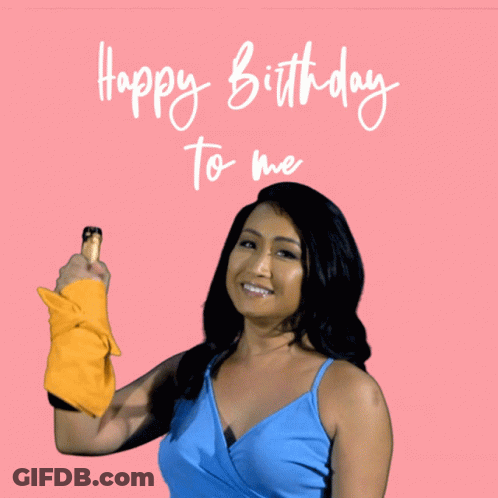 Woman In Blue Top Holding Yellow Towel Says Happy Birthday To Me GIF