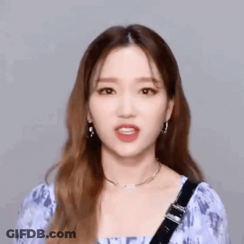 Woman In Blue Top With Earrings GIF