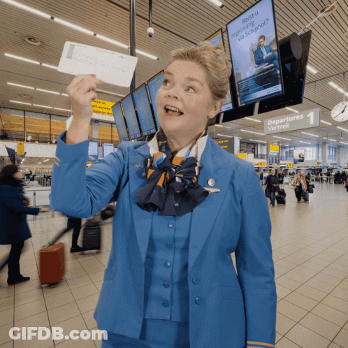 Woman In Blue Uniform Holding Ticket At Departures Wachtek GIF