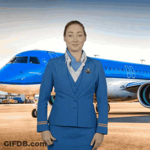 Woman In Blue Uniform In Front Of Airplane GIF