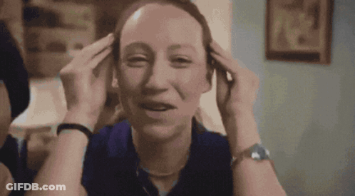 Woman In Blue Watch Holding Head GIF
