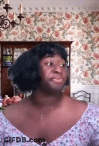 Woman In Blue Wig And Floral Top GIF