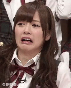 Woman In Bow Tie Making Funny Face In Crowd GIF