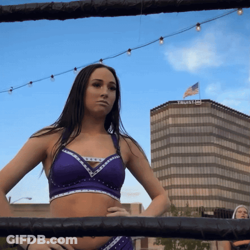 Woman In Boxing Ring In Front Of Trust Building GIF