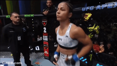 Woman In Boxing Ring With UFC Apex Sign GIF