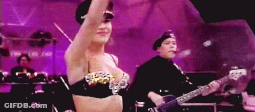 Woman In Bra Dancing While Man Plays Guitar GIF