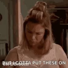 Woman In Bra Standing In Closet GIF